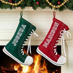 two christmas stockings hanging from a fireplace with the words merry christmas written in white and green