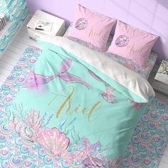 a bed with mermaid themed sheets and pillows