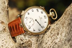 "A beautiful time piece, a classic Zenith pocket watch converted by Revenant Watches Stainless steel classic case, watch is approximately 48mm diameter. Weight is 179.9g Carrier is 316l stainless steel, with 0.925 silver retaining arms Brown Ostrich leather strap with a polished stainless steel quick release buckle. Watch keeps good time, is tested. A completely unique timepiece. Contained within a handmade solid walnut case with red satin finish All watches are certified by Revenant Watches Eac Luxury Automatic Pocket Watch With Round Dial, Luxury Pocket Watch With Polished Finish, Luxury Automatic Pocket Watch, Elegant Formal Pocket Watch With Skeleton Dial, Vintage Formal Watches With Rotating Bezel, Luxury Automatic Pocket Watch For Formal Occasions, Timeless Formal Pocket Watch With Subdials, Timeless Pocket Watch With Skeleton Dial, The Revenant