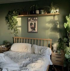 a dog laying on top of a bed in a room with green walls and plants