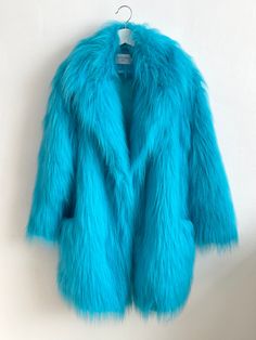 "Turquoise Oversize Fur Coat. Luxury, fluffy fabric, very soft. 100% polyester. Handmade made in London, UK.  Oversize style. Big collar. Long sleeves. Metal snap buttons (invisible) Two side pockets. Lenght 82cm - 1cm) Handmade in UK.  Model wears size S.  HOW TO CHOOSE A SIZE ?   Using a measuring tape, measure your bust, waist and hips (widest part) and compere with size chart.  SIZE CHART: (CM) B: Bust  H: Hips  XS - B: 83-88 cm  H: 90-95 cm  S - B: 88-93 cm H: 95-100 cm  M - B: 93-98 cm H: 100-105 L - B: 103-108 cm  H: 105-110 cm XL - B: 108-113 cm H: 110-115 cm CARE INSTRUCTIONS: Dry clean only, do not wash, do not iron, do not bleach.  Please message me before purchasing so I can check availability. If you wish this fur in any other colour, shorter or longer \"send message to seller Shaggy Fur Coat, Oversized Fur Coat, Oversize Coat, Fluffy Fabric, Oversize Style, Fluffy Jacket, Turquoise Fabric, Fluffy Coat, Fitted Coat