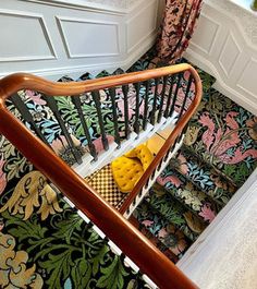 the stairs are decorated with colorful wallpaper