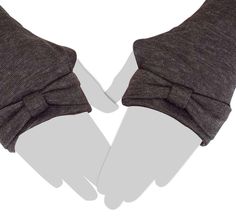 two gloves with bows on them are shown from above, one is gray and the other is black