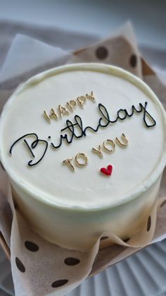 a birthday cake with the words happy birthday you written on it and a red heart