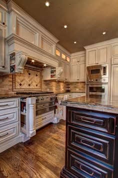 a large kitchen with white cabinets and wood floors