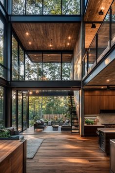 the inside of a modern house with wood floors and large windows on each side of the room