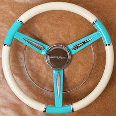 the steering wheel is blue and white with chrome spokes