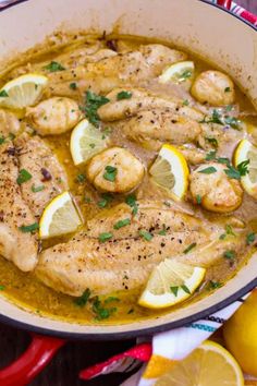 a pan filled with chicken and lemons on top of a table