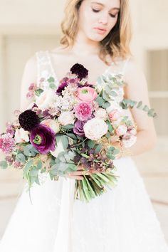 a woman holding a bouquet of flowers in her hands