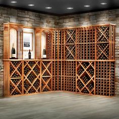 a wine rack in the corner of a room with stone walls and flooring is shown