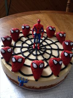 a spider man cake with strawberries on top