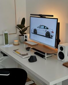 a desk with a monitor and speakers on it