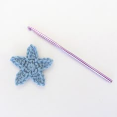 a crochet star next to a knitting needle