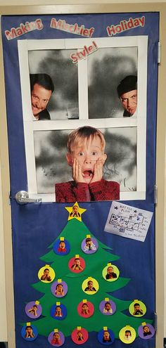 a child's christmas tree made out of paper and magnets on the front door