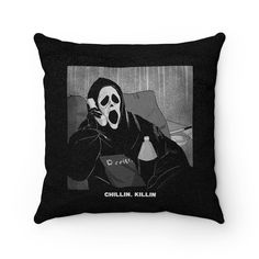 a pillow with a black and white image of a person wearing a mask on it