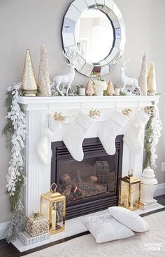 a fireplace decorated for christmas with white stockings and gold ornaments on it's mantle