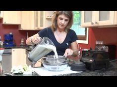 a woman pouring something into a bowl in the kitchen