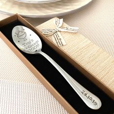 a spoon in a gift box on a table