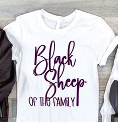 black sheep of the family t - shirt with purple lettering on it and shoes next to it