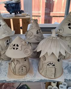 several clay houses sitting on top of a table