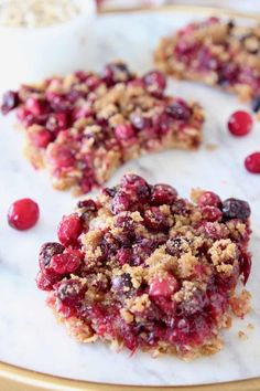 cranberry bars on a plate with cherries