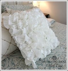 a bed with white flowers on the pillows