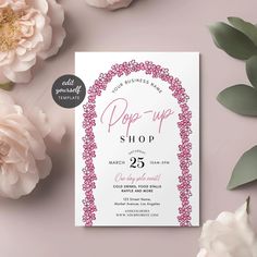 the pop up shop flyer is shown with pink flowers and greenery in front of it