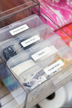 three plastic containers with labels on them and some toiletries in the bins next to each other