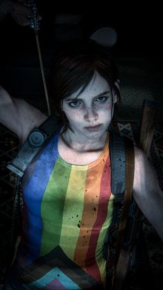 a woman with blood on her face holding a baseball bat and wearing a rainbow shirt