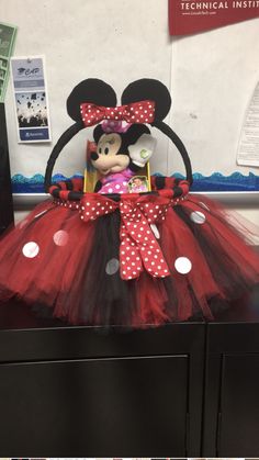 the minnie mouse costume is on display in front of an office cubicle at disney world