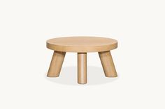 a small wooden stool with two legs on the bottom and one leg up to the side