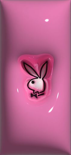 a pink square object with a rabbit face on it's side and black outline in the middle