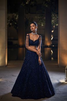 This navy lehenga set features very fine sequin and crystal embroidery. The blouse has a sweetheart neck and waterfall beads from the shoulders. The outfit is paired with an embroidered net dupatta.﻿From Seema Gujral's Celeste collection. DELIVERY TIMEPlease allow 4-6 months for your outfit to arrive. FABRIC DETAILSNet. Professional cleaning only. Blue Sequin Lehenga, Navy Blue Lehenga, Sequin Lehenga, Seema Gujral, Baju Kahwin, Cocktail Party Outfit, Sangeet Outfit, Reception Outfit, Indian Outfits Lehenga