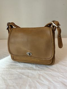 Vintage Coach Rambler Tan Leather Legacy Shoulder Crossbody Bag 9061. You can see the amazing quality of the leather of this bag. In great condition. There is a small ink mark inside the pocket, but it doesn't show on the outside. See pictures, as any problems will be shown in the pictures. Size: 9"  X 8"  X 3" W ITEM IN PICTURE IS WHAT YOU WILL RECEIVE Shipping: I provide free shipping insured by USPS. I am not responsible for any item after it is with USPS. Returns: I accept returns, but the buyer must pay for return shipping regardless of the reason for return. Items must be returned within 14 days of receipt. Combined shipping: I am happy to combine shipping for multiple purchases for free. Classic Soft Leather Crossbody Satchel, Classic Saddle Bag With Adjustable Strap For Everyday, Classic Saddle Shoulder Bag For Daily Use, Travel Crossbody Shoulder Bag With Coin Pocket, Classic Saddle Flap Bag For Everyday Use, Classic Everyday Carry Saddle Shoulder Bag, Classic Saddle Shoulder Bag For Everyday Carry, Classic Shoulder Saddle Bag For Everyday Carry, Classic Shoulder Bag With Coin Pocket