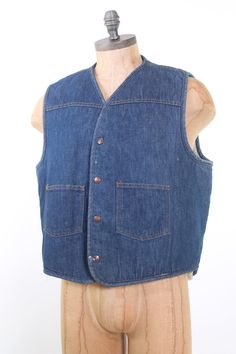 "vintage 1970s dark denim Carhartt vest. Extra warm cream sherpa fleece lining. 2 flat front pockets & Carhartt logo snaps. Looks great over cowboy shirts, or other work wear. Size XL. 44\" chest, 24\" Long Very good condition has some white spots but hard to see." Cotton Medium Wash Vest Outerwear, Dark Wash Cotton Vest With Pockets, Vintage Cotton Vest Outerwear, Vintage Cotton Denim Vest With Pockets, Vintage Cotton Vest With Button Closure, Vintage Denim Blue Vest With Pockets, Vintage Denim Blue Cotton Vest, Vintage Cotton Vest Medium Wash, Vintage Cotton Vest In Medium Wash