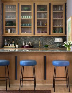 two blue stools are in front of the bar