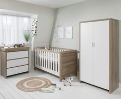 a baby's room with a crib, dresser and changing table