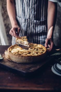 a person cutting a pie with a knife