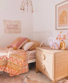 a bed room with a neatly made bed and dresser