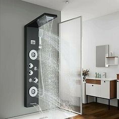 an open shower in a bathroom with wooden floors