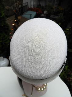 "LOVELY Classy Vtg 1940's Ladies White & Black Velvet Ribbon Woven Veiled Bumper Hat sz 21\" Diameter This is such a fun vintage Bumper hat from the 1940's. It's in just impeccable condition with no flaws I could note what so ever. The hat is a bright white woven fabric which feel synthetic to me. It has a short little brim which tilts up slightly at the sides with a gorgeous black veil attached to the front of the hat. There's a beautiful black velvet ribbon round the crown of the hat with Fitted Retro Cream Hat, Retro Fitted Cream Hat, Retro Cream Hat, Vintage Adjustable Hat Bands For Kentucky Derby, Retro Fitted Cloche Hat, White Vintage Top Hat With Curved Brim, White Vintage Cloche Mini Hat, Vintage White Cloche Mini Hat, White Fitted Vintage Top Hat