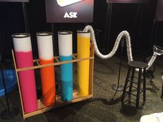 there are many different colored cylinders in this display