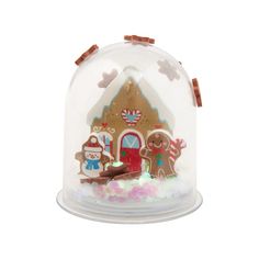 a snow globe with gingerbreads and christmas decorations on it's sides, in front of a white background