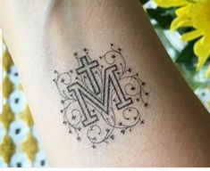 a small tattoo on the arm of a woman's left arm, which is decorated with ornamental designs