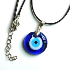 The Evil Eye concept dates back thousands of years, being wildly spread through the Mediterranean Region and the Middle East. It is believed that one can be harmed by the evil eye stare of an envious person, or by the lengthy praise. This can occur either consciously or unconsciously. The desire-oriented waves generated in a person about another individual are transmitted to that individual and an evil eye is cast on them. In Europe, it is believed that envious or malicious looks can bring bad l Blue Symbolic Evil Eye Jewelry, Blue Evil Eye Jewelry For Meditation, Blue Amulet Necklace For Good Luck, Spiritual Blue Evil Eye Jewelry, Symbolic Blue Necklace With Round Pendant, Symbolic Blue Round Pendant Necklace, Blue Adjustable Amulet Necklace, Blue Round Pendant Necklace For Good Luck, Handmade Symbolic Blue Necklaces