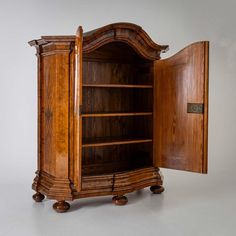 an old wooden bookcase is open to show the contents