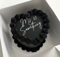 a heart shaped cake in a box with writing on it