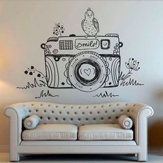 a couch sitting in front of a wall with a camera on it