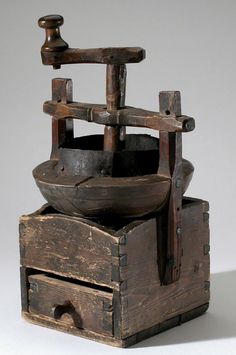 an old wooden grinder sitting on top of a table