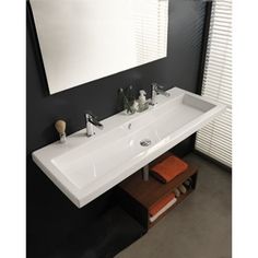 a white sink sitting under a mirror in a bathroom